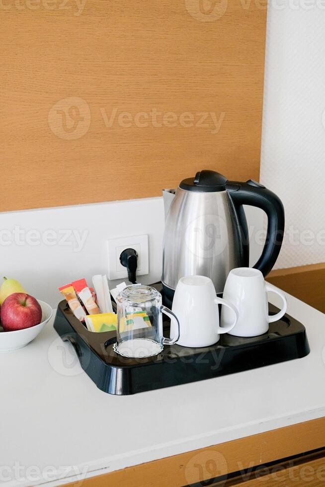 tea and coffee set for self service on wood shelf in luxury hotel room photo